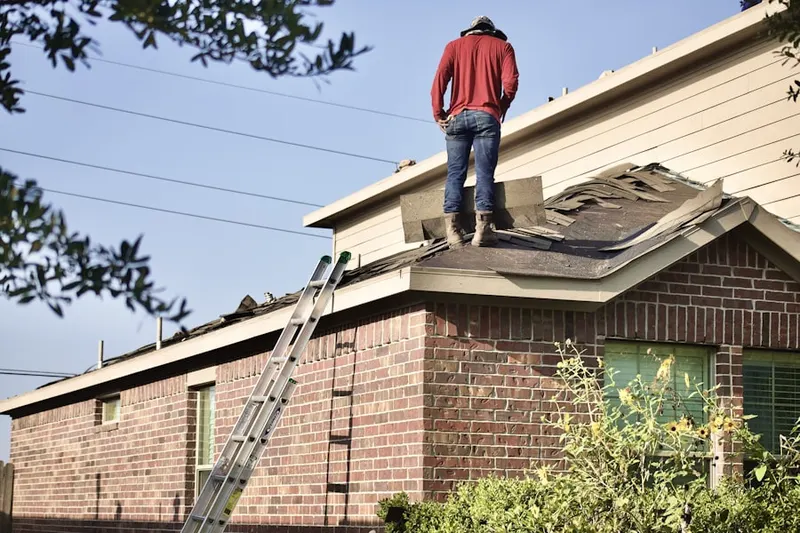 Professional roofer working on a residential roof in Six Forks